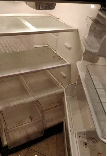 Stained fridge interior before cleaning in Espoo