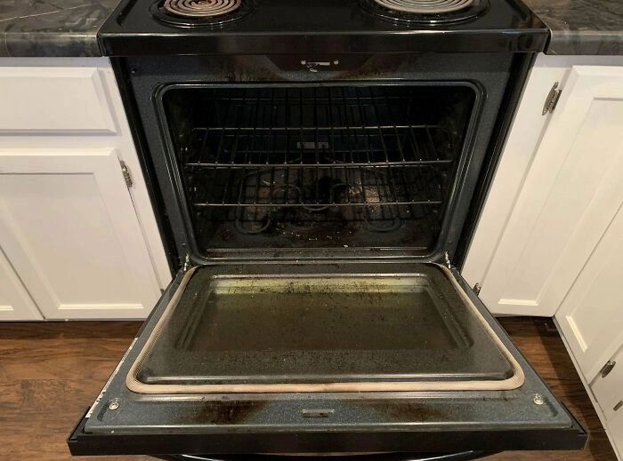 Burnt oven interior before deep cleaning in Espoo